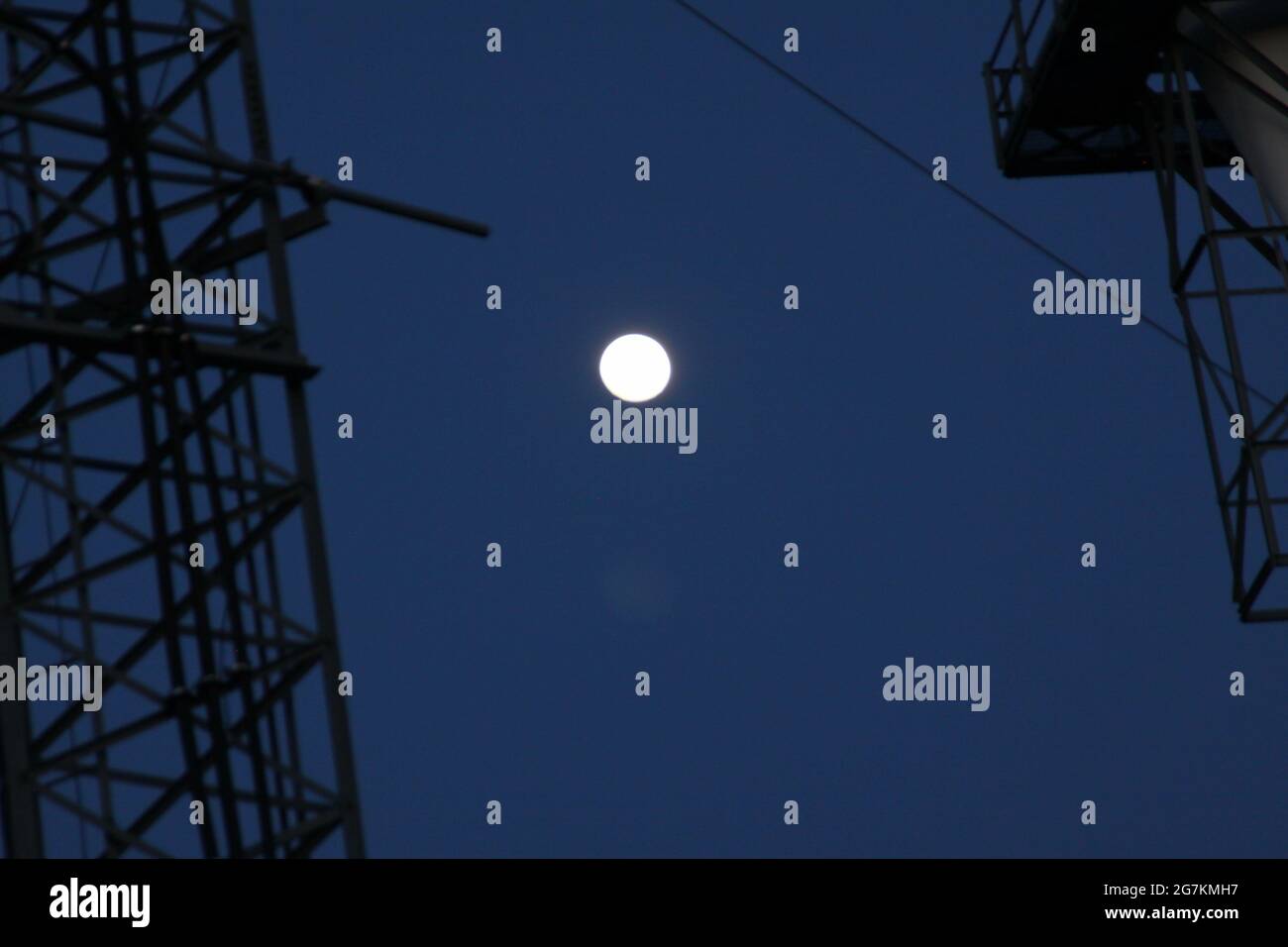 Low angle shot of the moon on blue sky background Stock Photo - Alamy