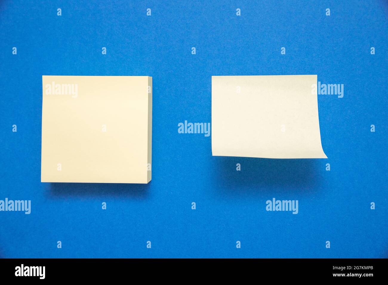 Two white sticky notes with space for text isolated on blue background Stock Photo