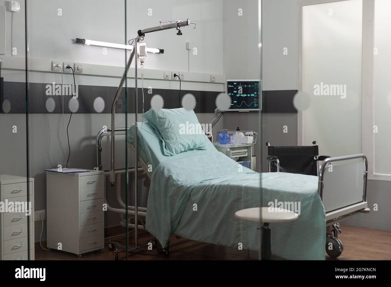 Clean hospital room interior during day time with comfortable bed and