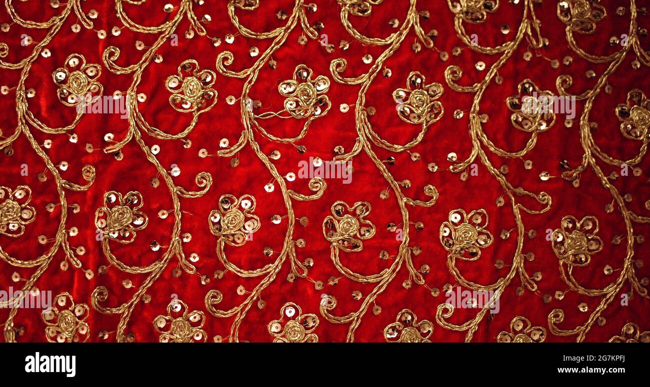 Texture of Indianstyle embroidered fabric with flowershaped ornaments