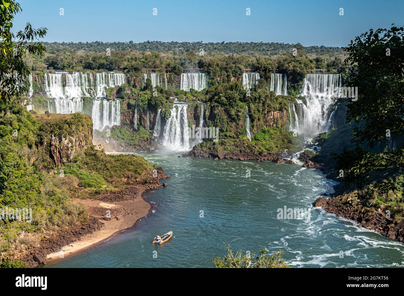 A tour boat cruises toward Iguazu Falls as seen from the Brazilian side Stock Photo