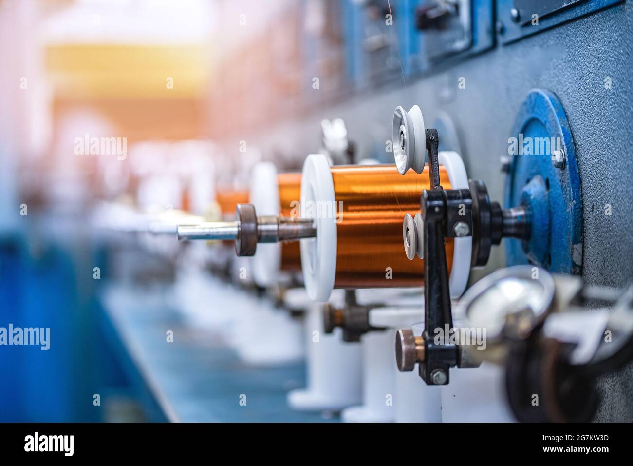 Production of copper wire, bronze cable in reels at factory with light