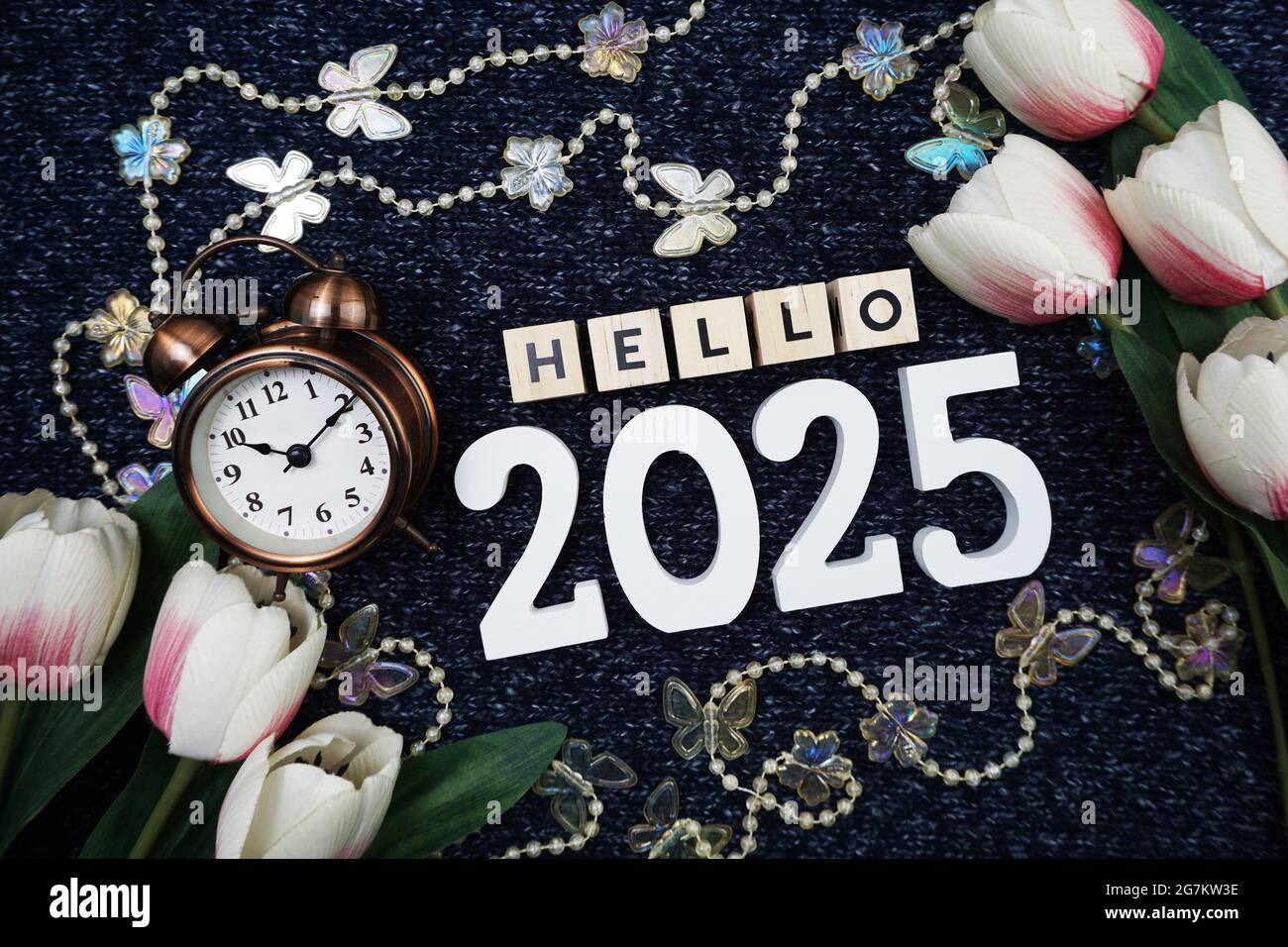 Hello 2025 alphabet letter decorate with alarm clock on blue knitted