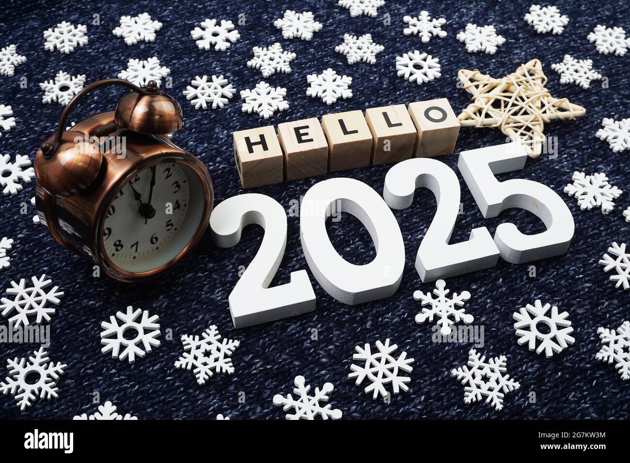Hello 2025 alphabet letter decorate with alarm clock on blue knitted