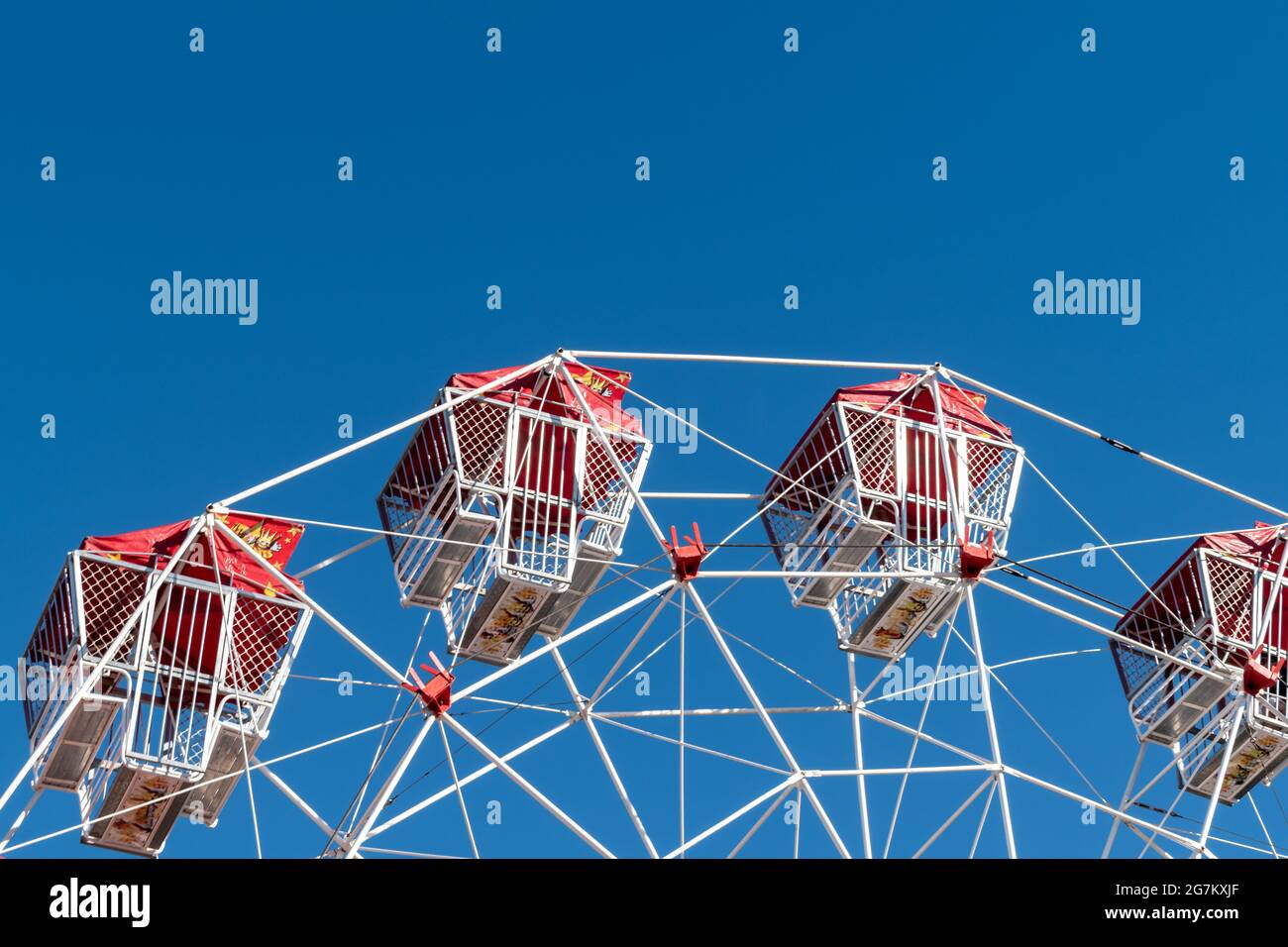 Low angle view of a ferris wheel against blue sky in sideshow alley at the Redcliffe Show in Queensland, Australia Stock Photo