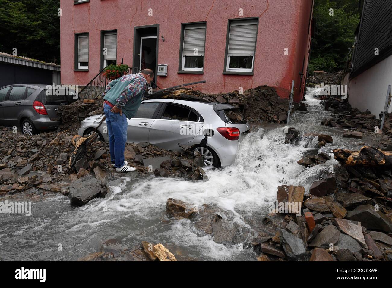 Hagen, Germany. 15th July, 2021. A resident looks at the damage caused by the flooding of the