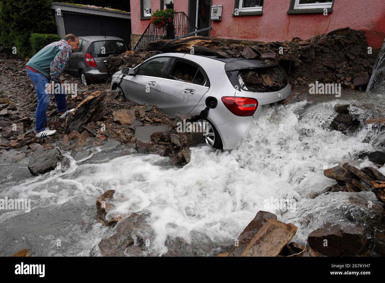 Hagen, Germany. 15th July, 2021. A resident looks at the damage caused by the flooding of the