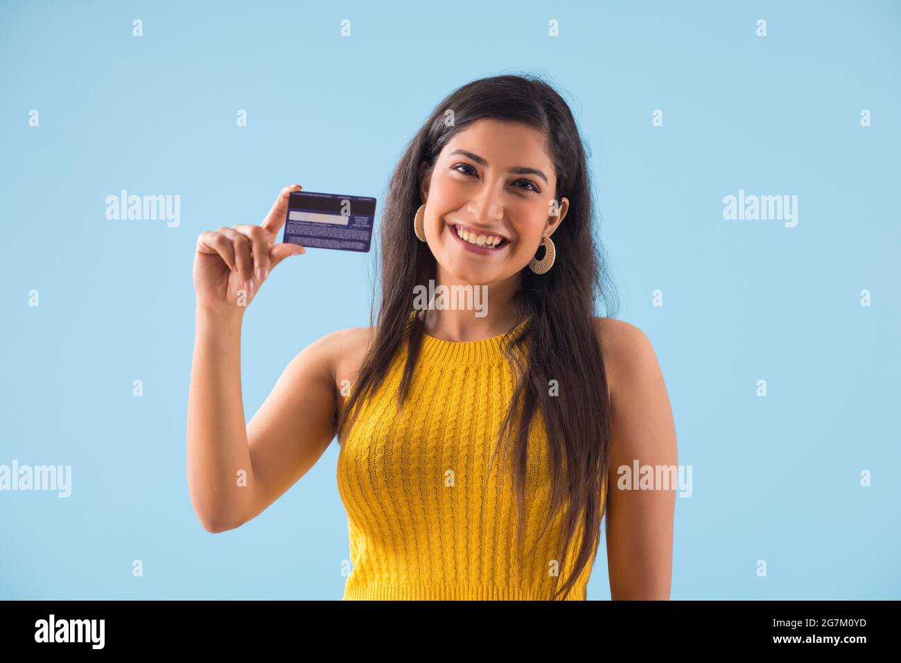 A young woman showing her credit card . Stock Photo