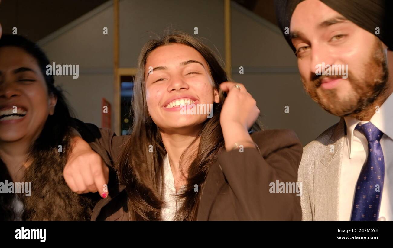 Young Indian co-workers wearing suits and smiling Stock Photo