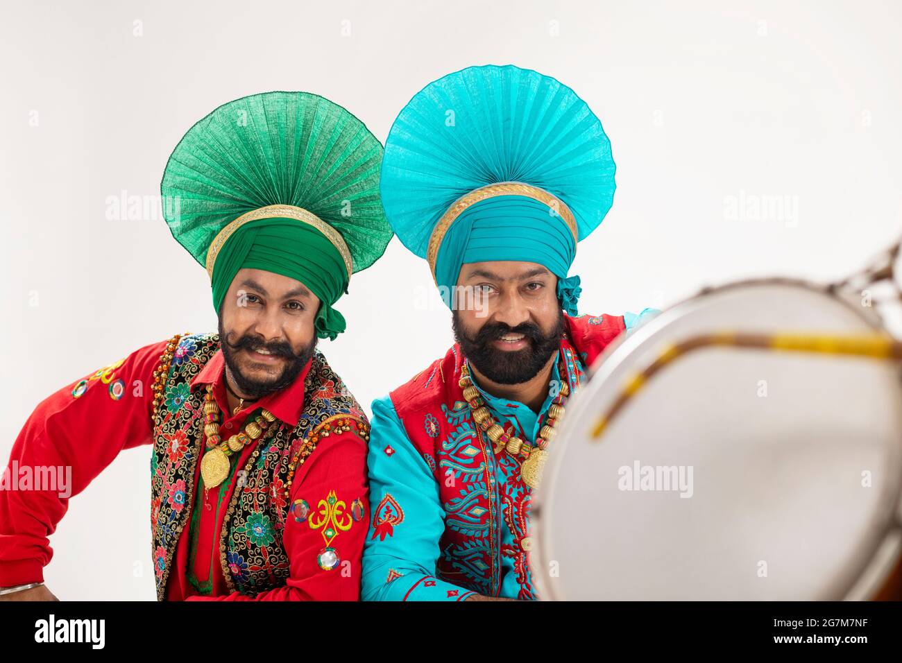 Two Bhangra dancer sitting as a highlighted backdrop for a Dhol Stock