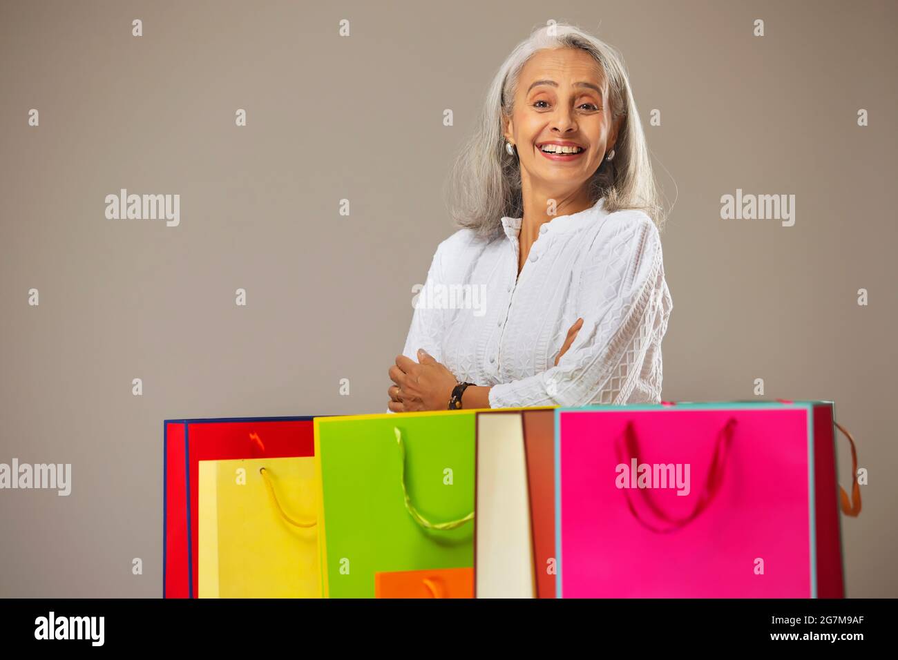 Woman carry bags elderly hires stock photography and images Alamy