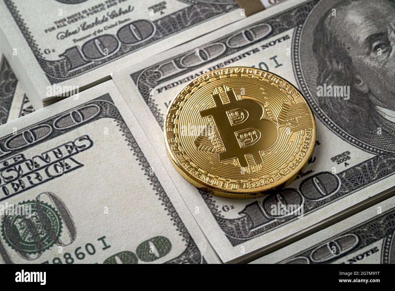 Siny golden bitcoin coin over dollar bills with copy space Stock Photo