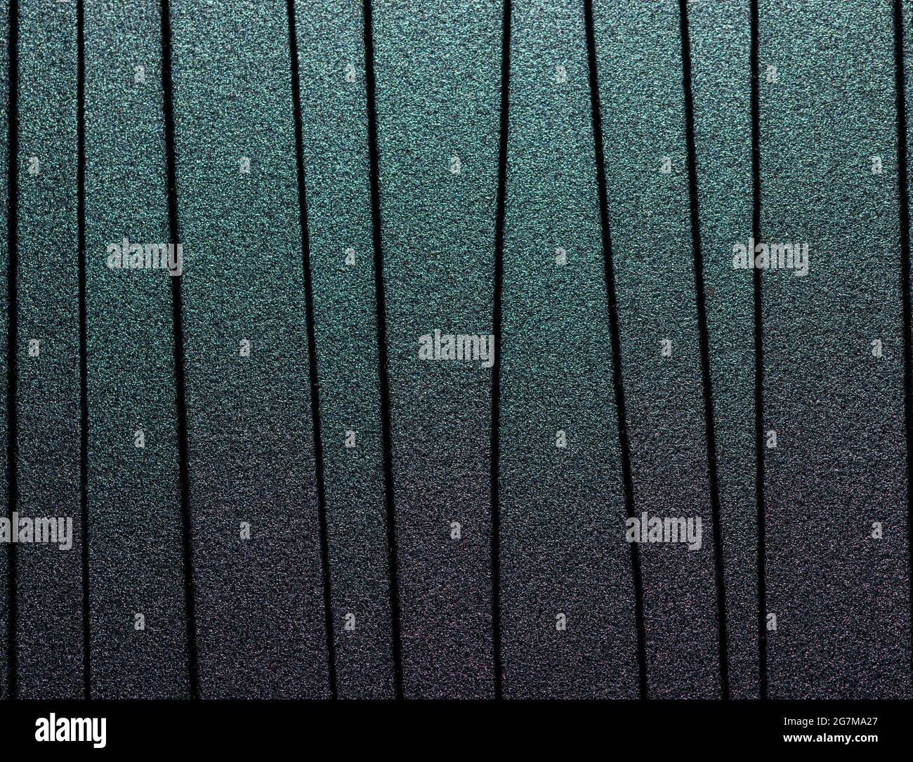 Lined black metal background with chameleon effect. Stock Photo
