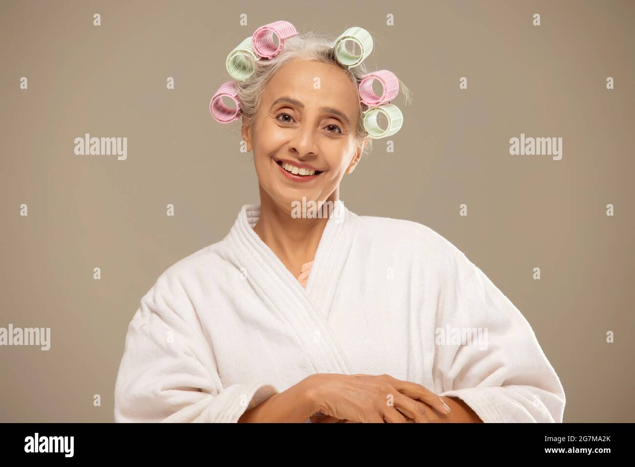 An old woman styling hair with rollers Stock Photo Alamy