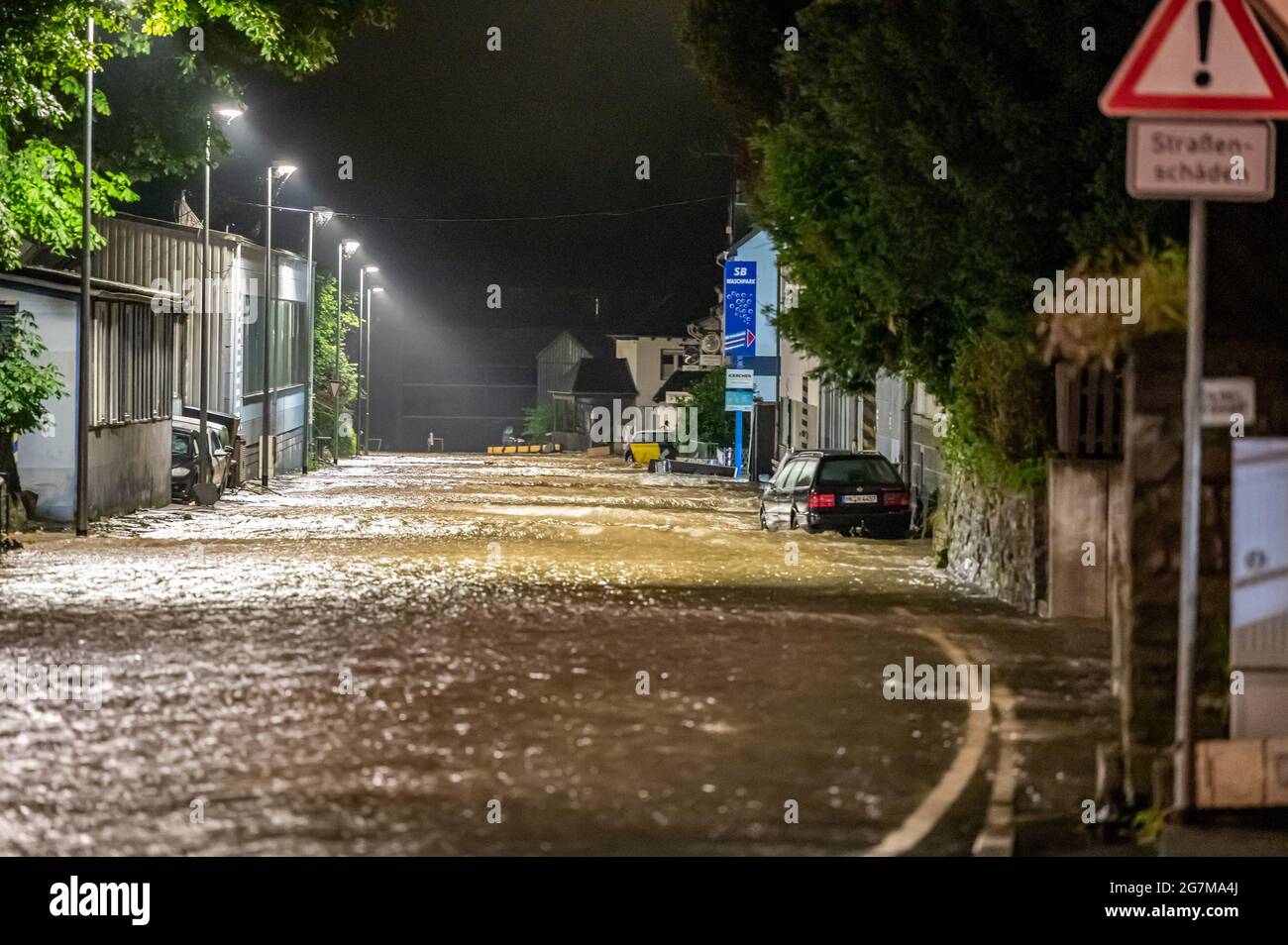 Altena, Germany. 15th July, 2021. Flooded streets in Altena after heavy rainfall. Altena in the Sauerland region was temporarily inaccessible after landslides and flooding. Credit: Markus Klümper/dpa/Alamy Live News Stock Photo