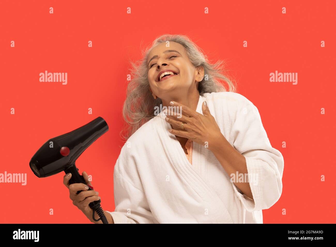 Senior woman blow drying hair hires stock photography and images Alamy