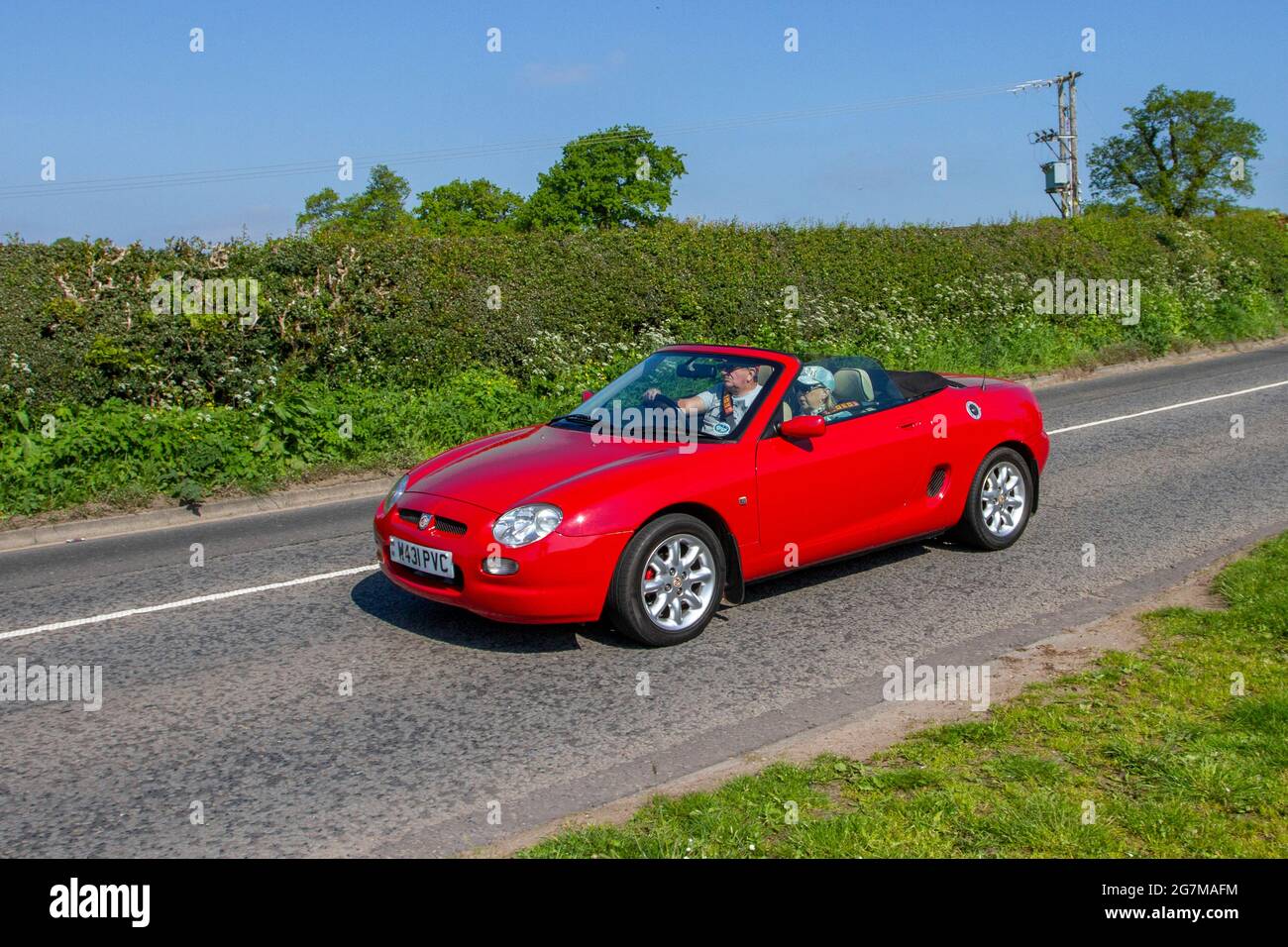 2000 MG Mgf red roadster 1796cc petrol cabriolet en-route to Capesthorne Hall classic May car show, Cheshire, UK Stock Photo
