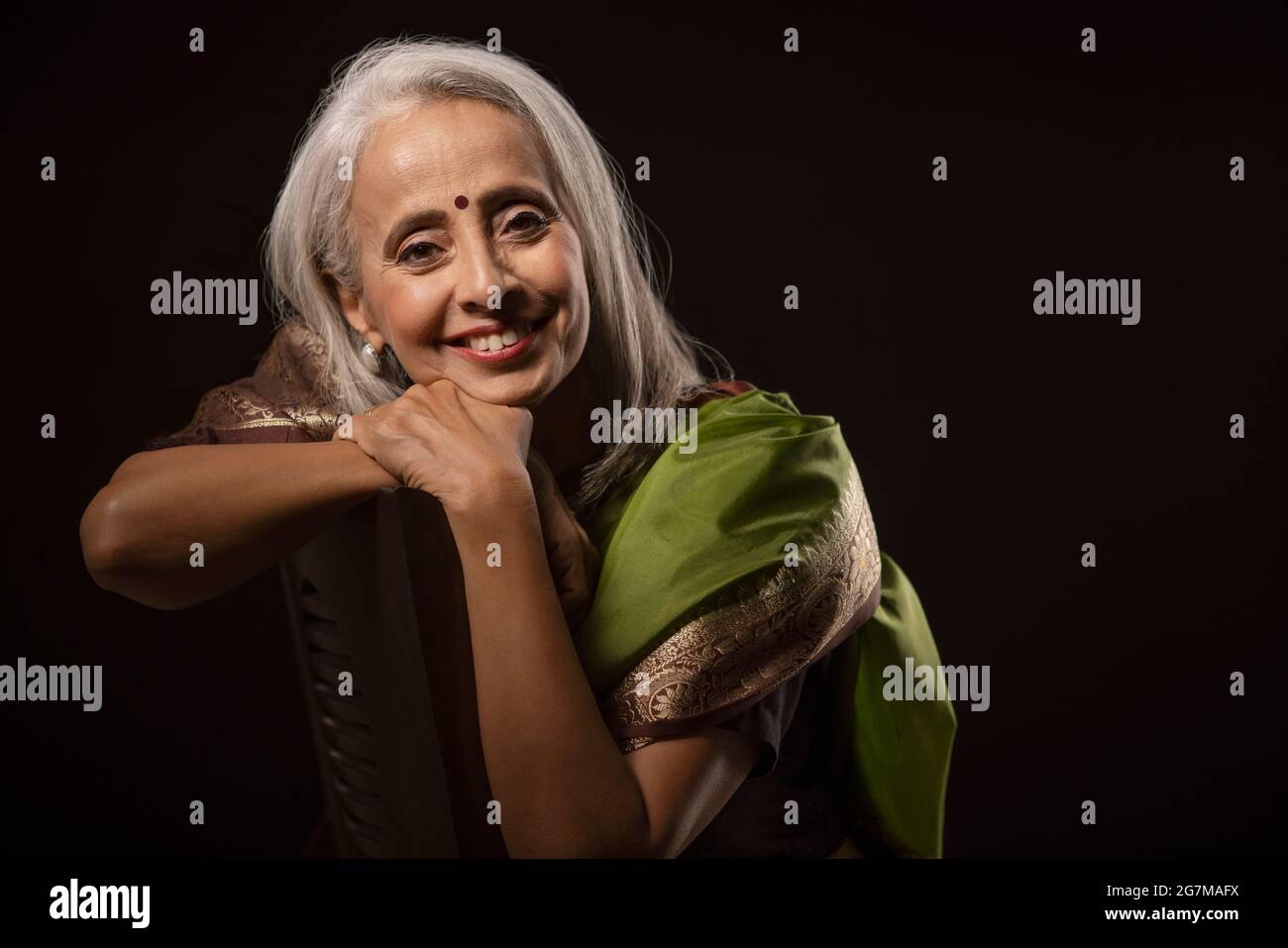 Portrait of old beautiful woman well dressed in a saree. Stock Photo