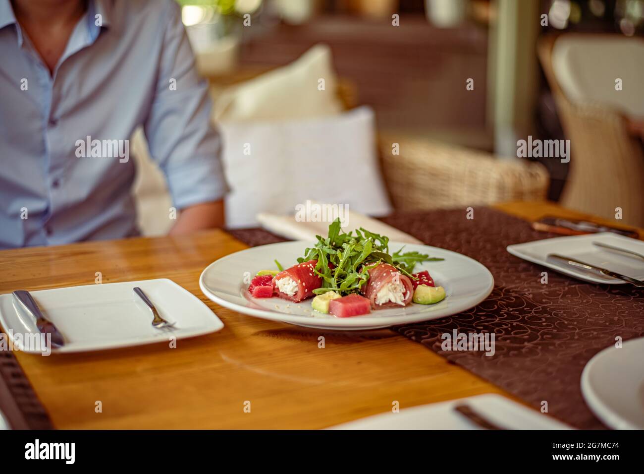 Salad of red fish Salmon, roll with Kamchatsky king crab, arugula, avocado, sesame and oil Stock Photo