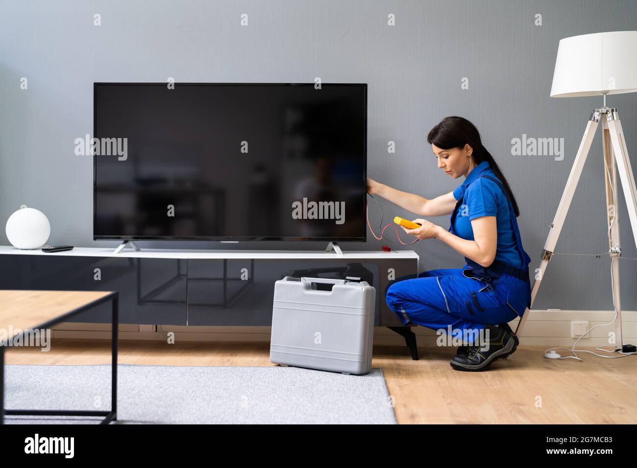 Electrician Repairing Television Or TV Appliance. Fixing Screen Stock