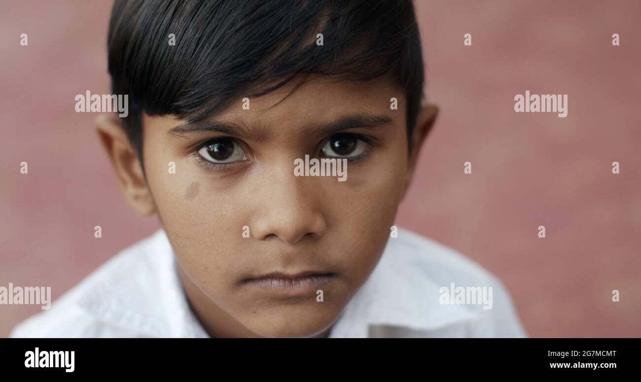 High angle shot of an indian male kid portrait on red background Stock Photo