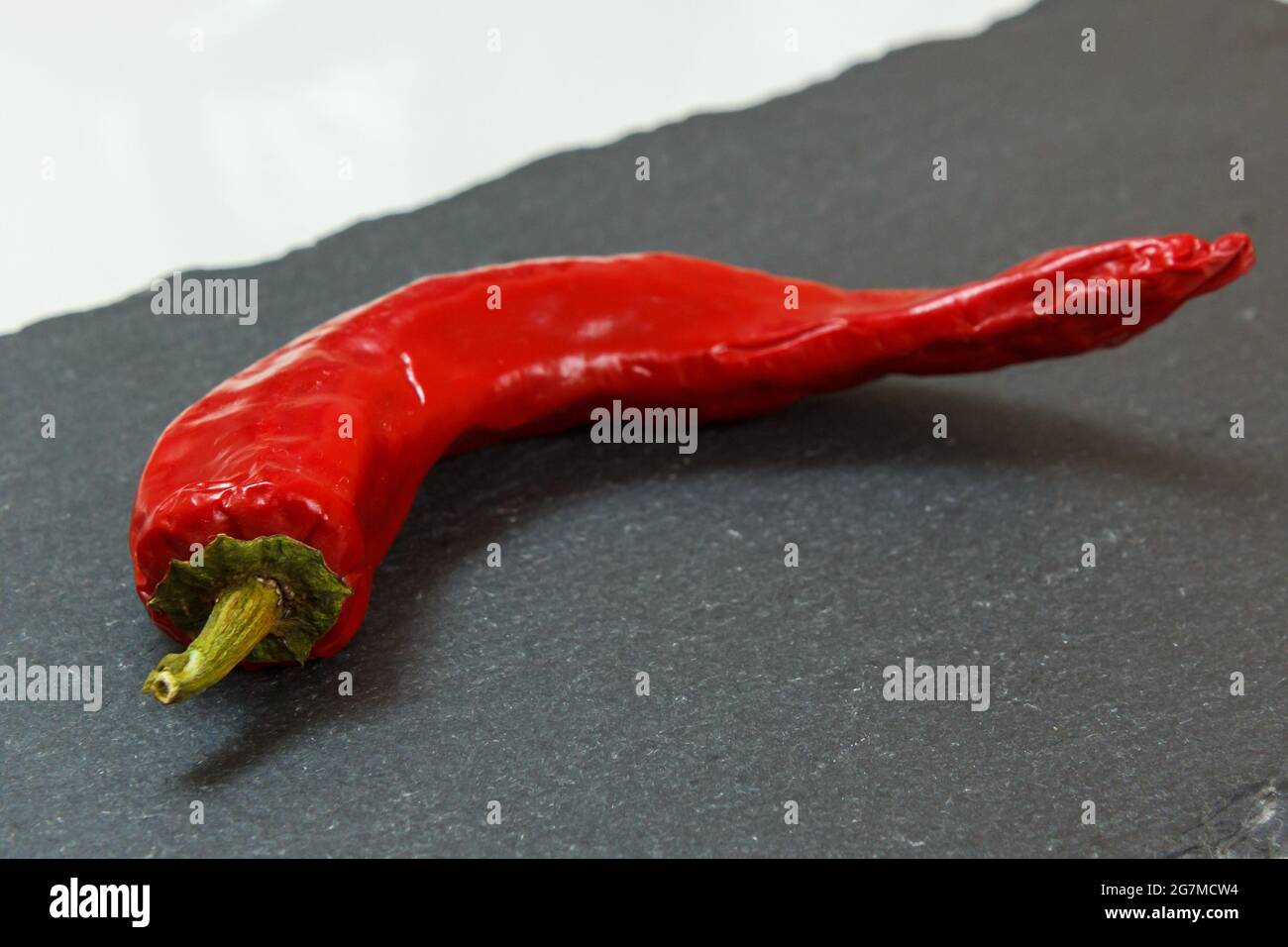 Red hot pepper on the stone cutting board Stock Photo - Alamy