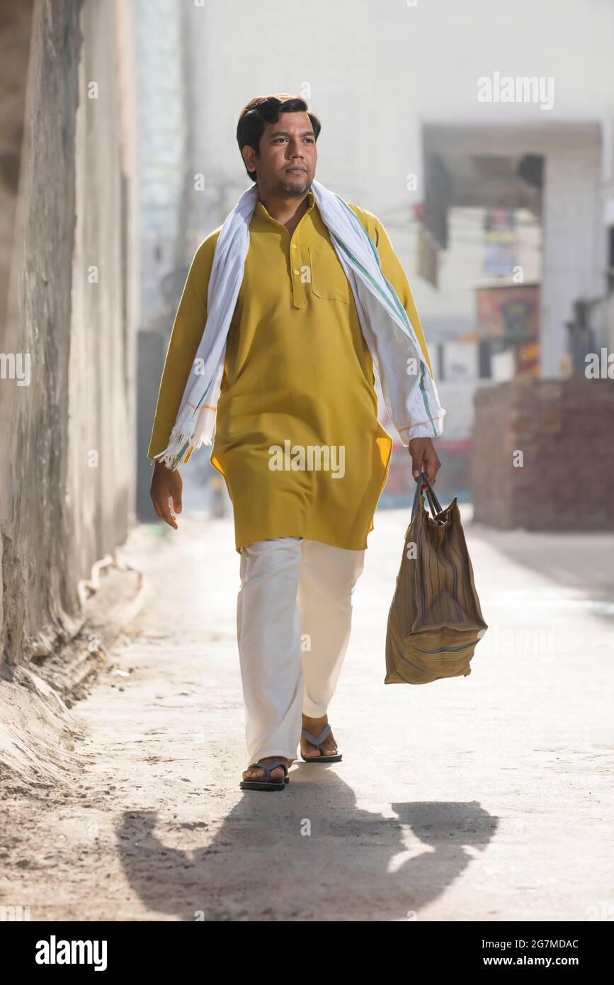 Indian village people walking with bag hi-res stock photography and ...