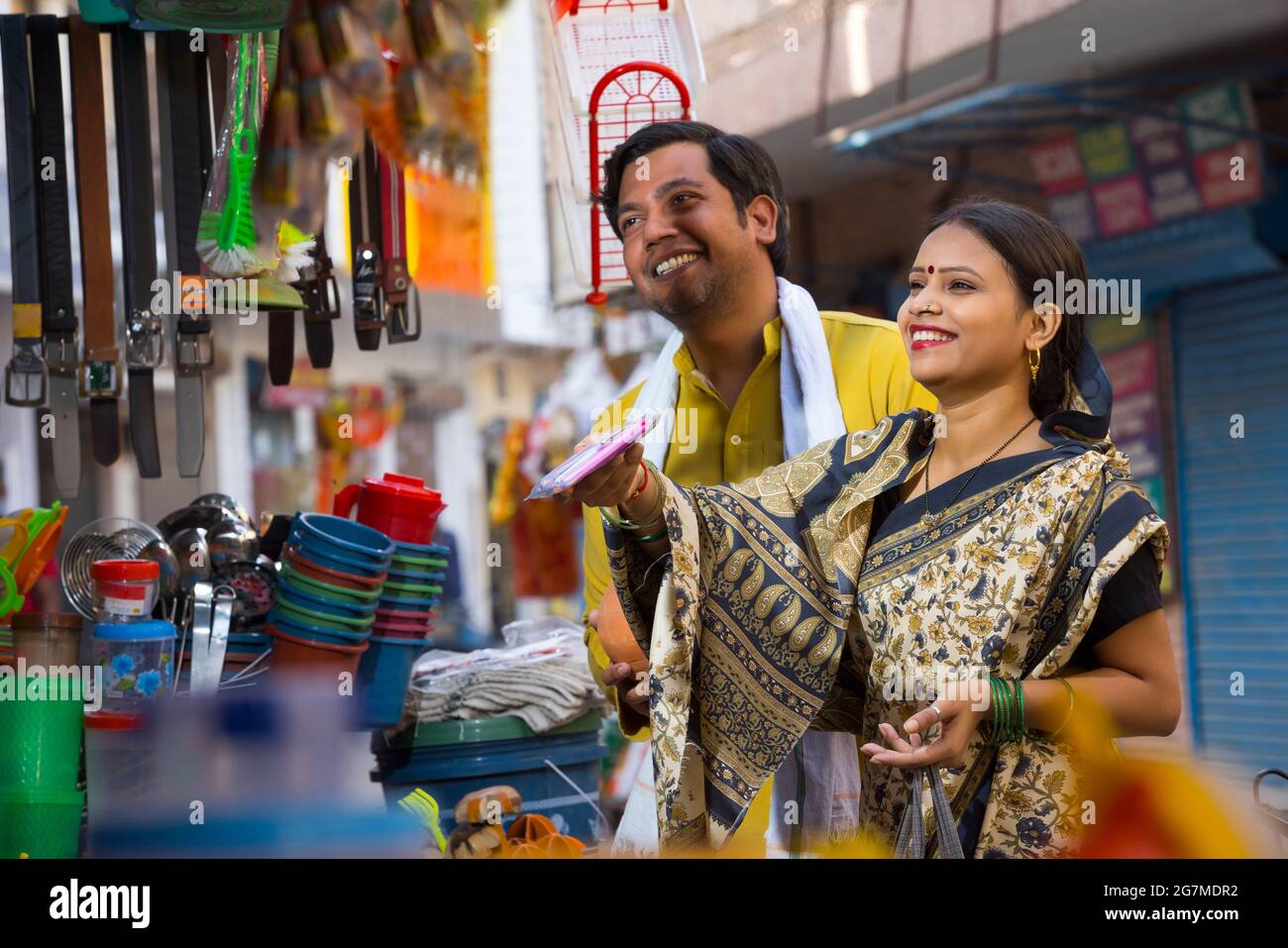 A RURAL HUSBAND AND WIFE HAPPILY SHOPPING TOGETHER FOR HOUSEHOLD ITEMS Stock Photo