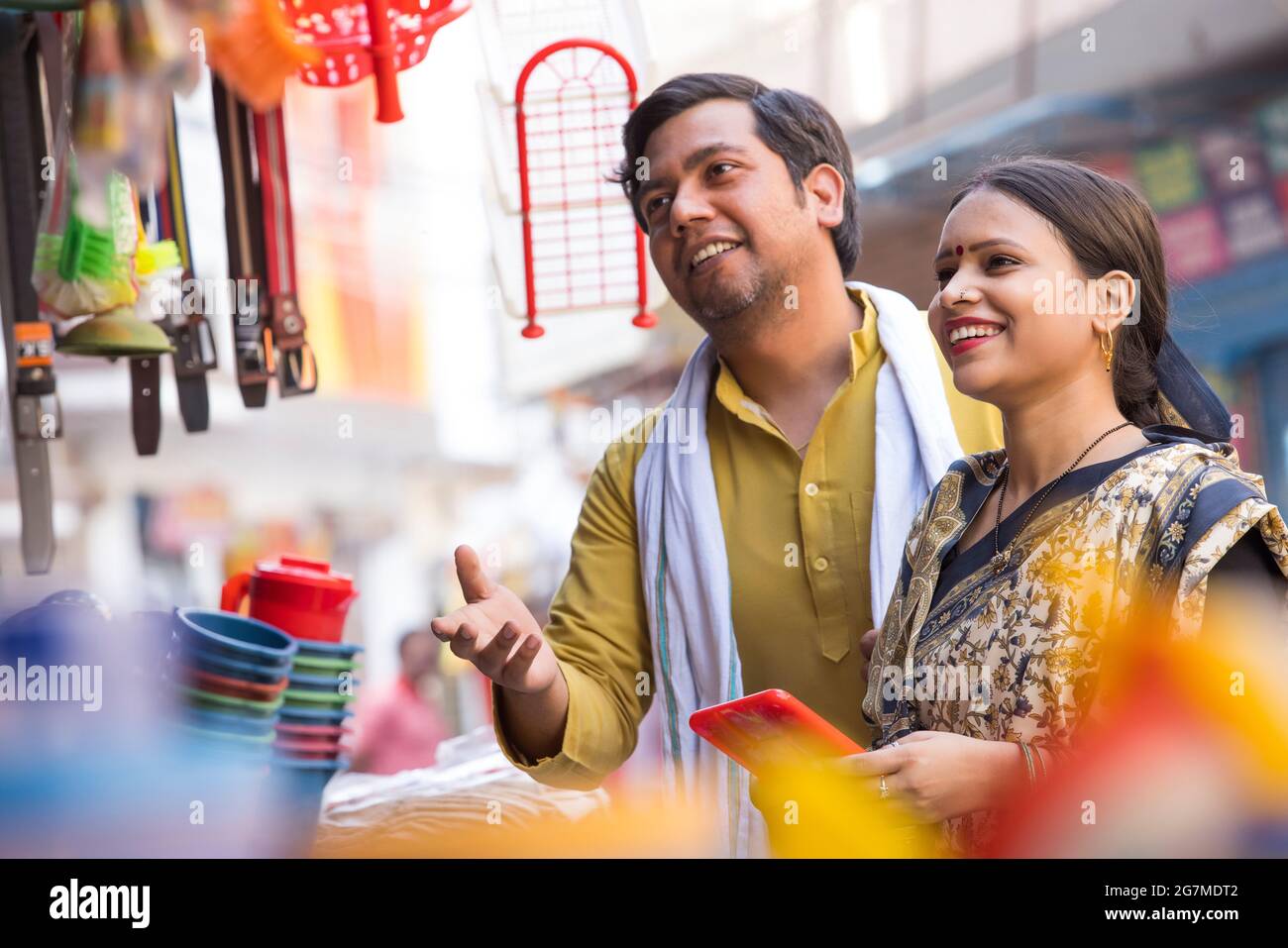 A RURAL MAN AND WIFE BUYING HOUSEHOLD ITEMS TOGETHER Stock Photo