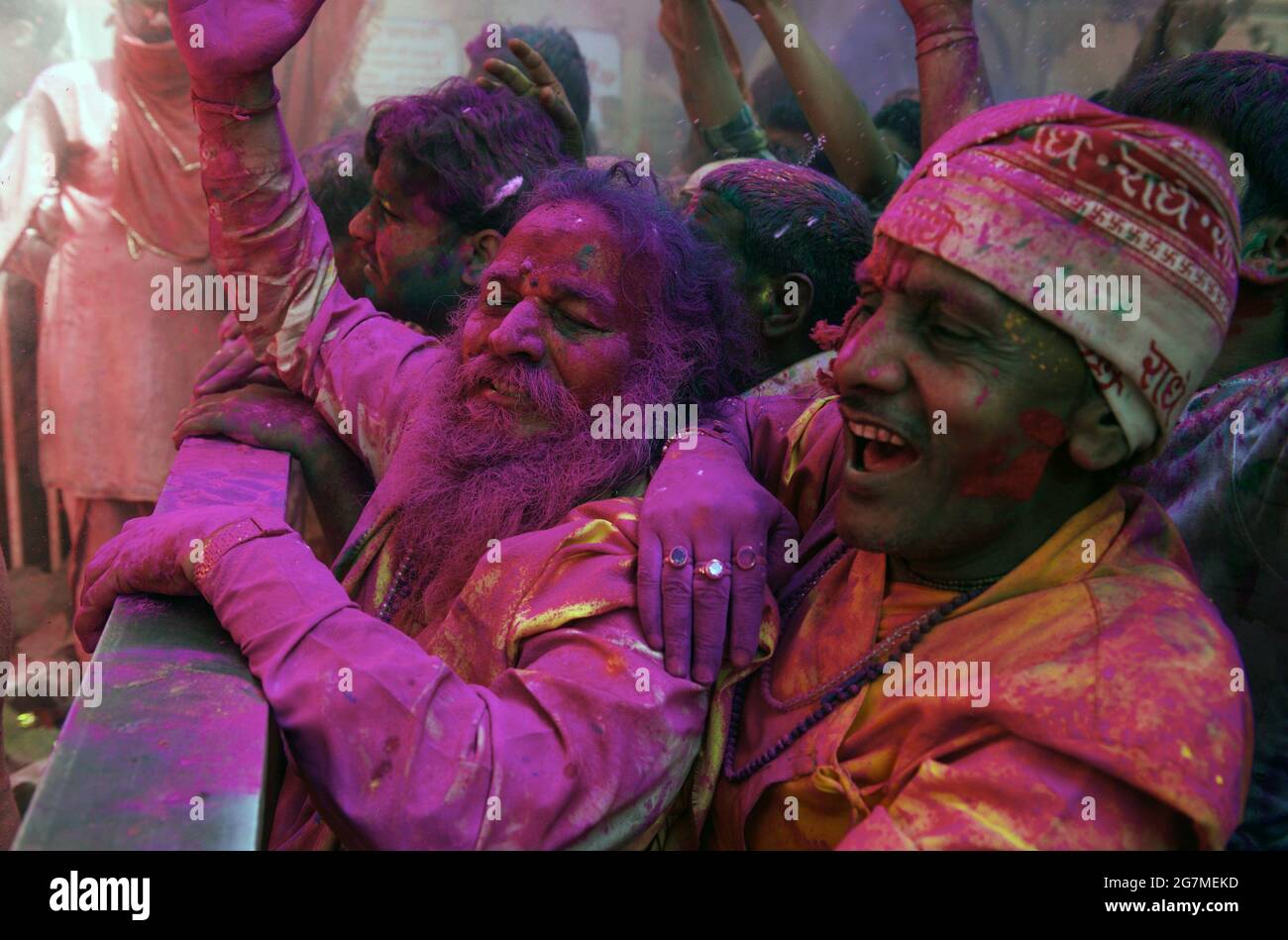 Revellers gather at the Shriji Temple (Laadli Sarkar Mahal), during Lathmar Holi, smeared with coloured powder. It is held during a full moon and the Stock Photo