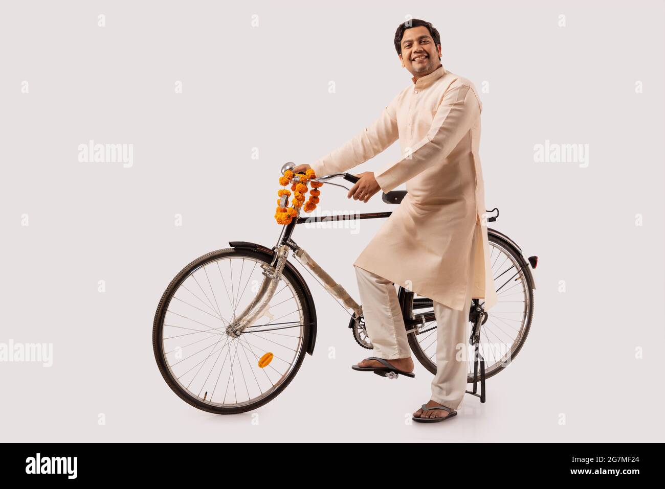 A HAPPY RURAL MAN POSING IN FRONT OF CAMERA WITH BICYCLE Stock Photo