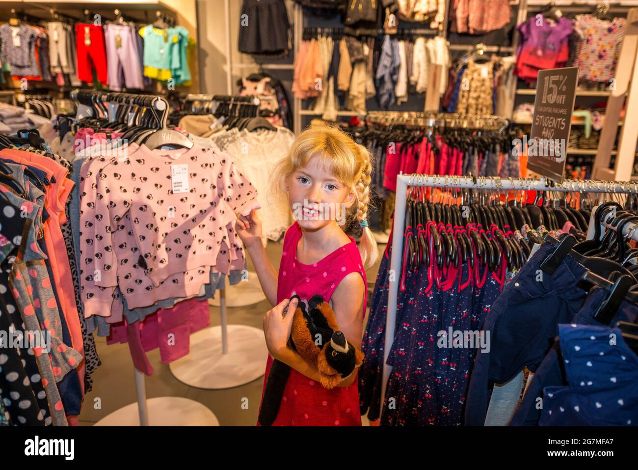 young child shopping for clothes,Naples,Florida,USA Stock Photo