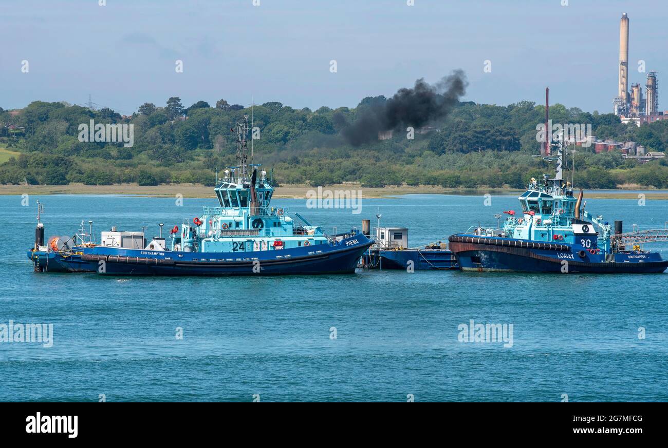 Southampton Water, England, UK. 2021.  Two ocean going tugs on a berth mid Southampton Water, England, UK. Stock Photo