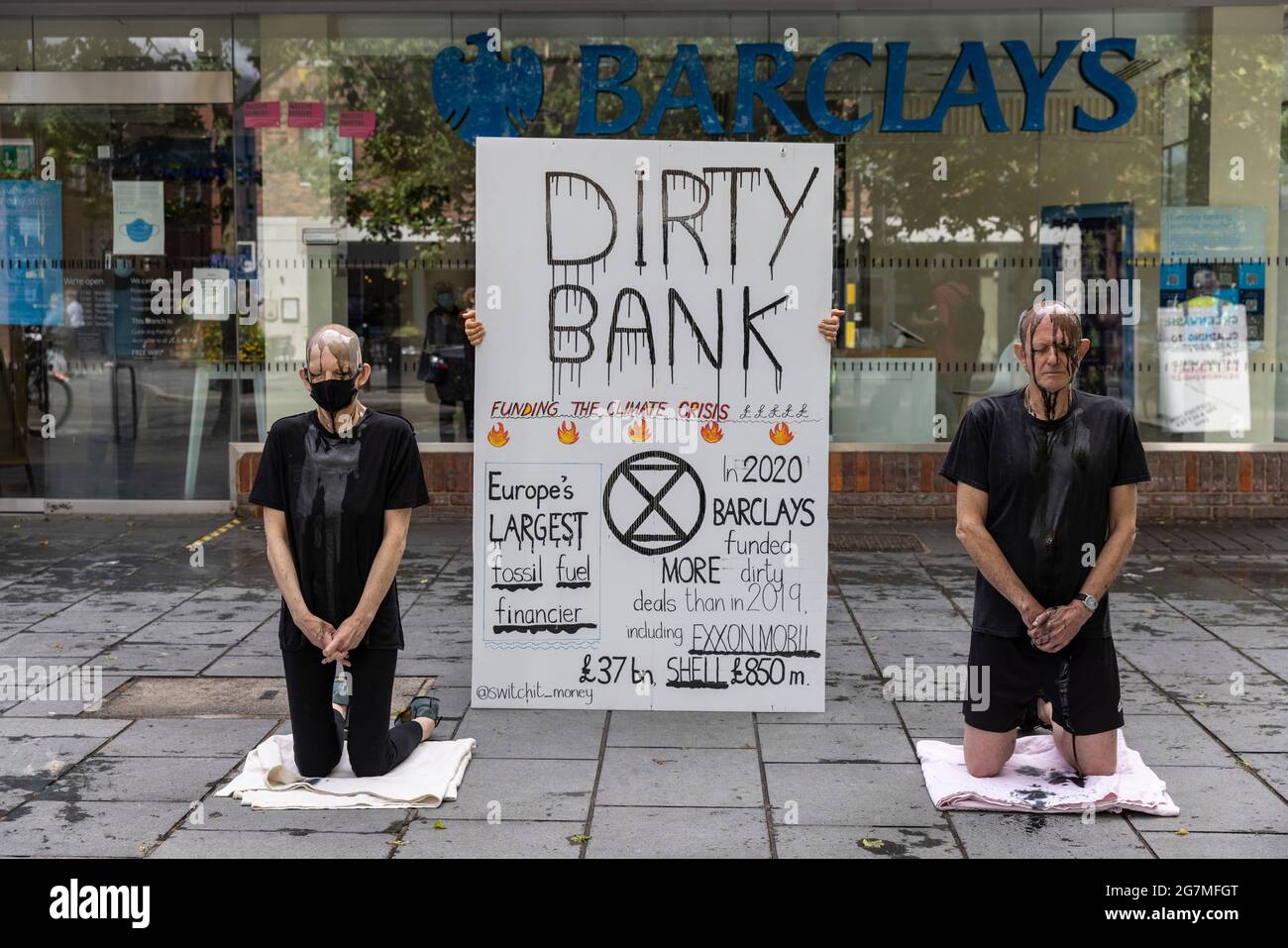 Climate protesters outside a Barclays Bank demonstrating against the banks financial investment in fossil fuels, St Albans, Hertfordshire, England, UK Stock Photo