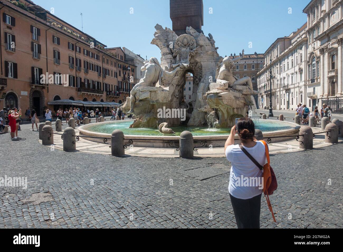 Rome, Italy - July 2021 - A female tourists taking photo in Piazza Navona Stock Photo