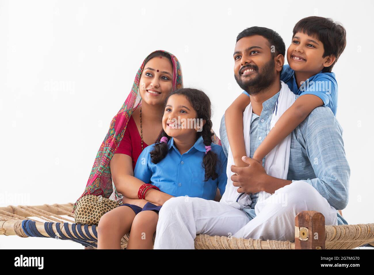 PORTRAIT OF A HAPPY RURAL FAMILY LOOKING AWAY FROM CAMERA AND POSING Stock Photo