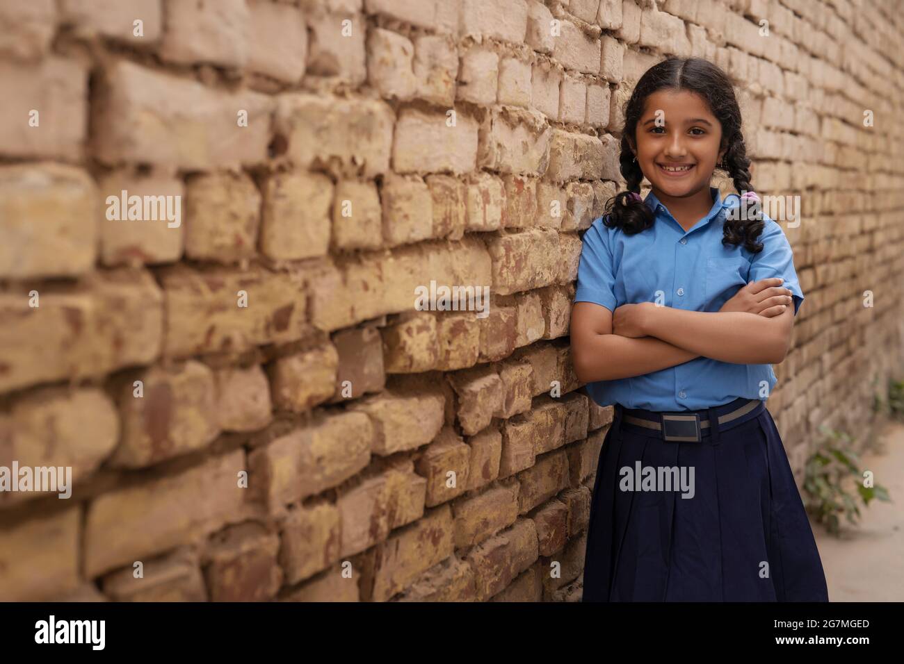 PORTRAIT OF A RURAL YOUNG GIRL POSING HAPPILY IN FRONT OF CAMERA Stock Photo