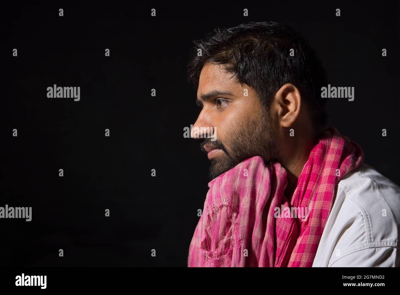A TIRED LABOURER LOOKING AWAY AND THINKING Stock Photo