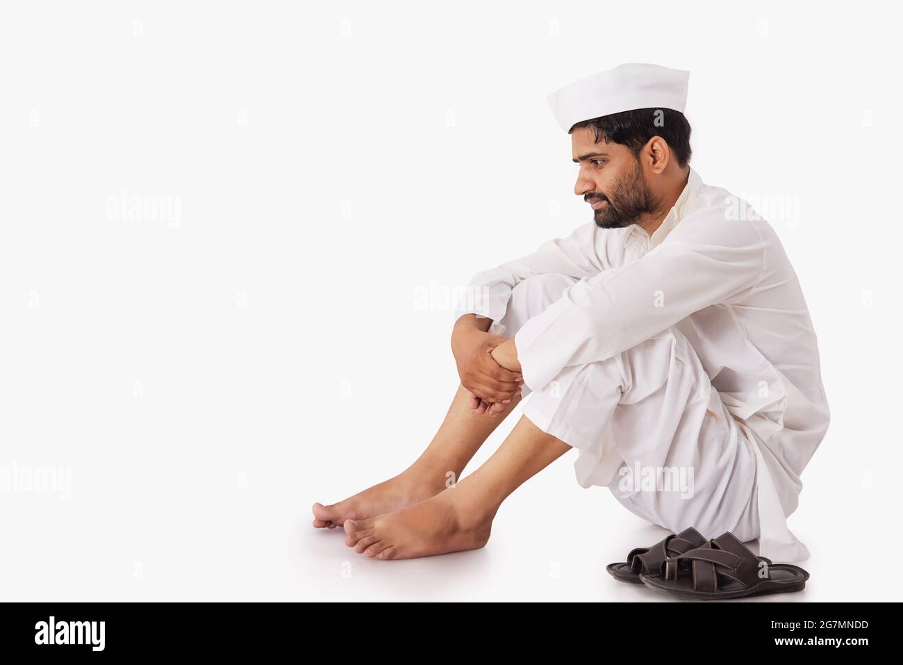 A COMMON MAN SITTING AND LOOKING DOWN Stock Photo