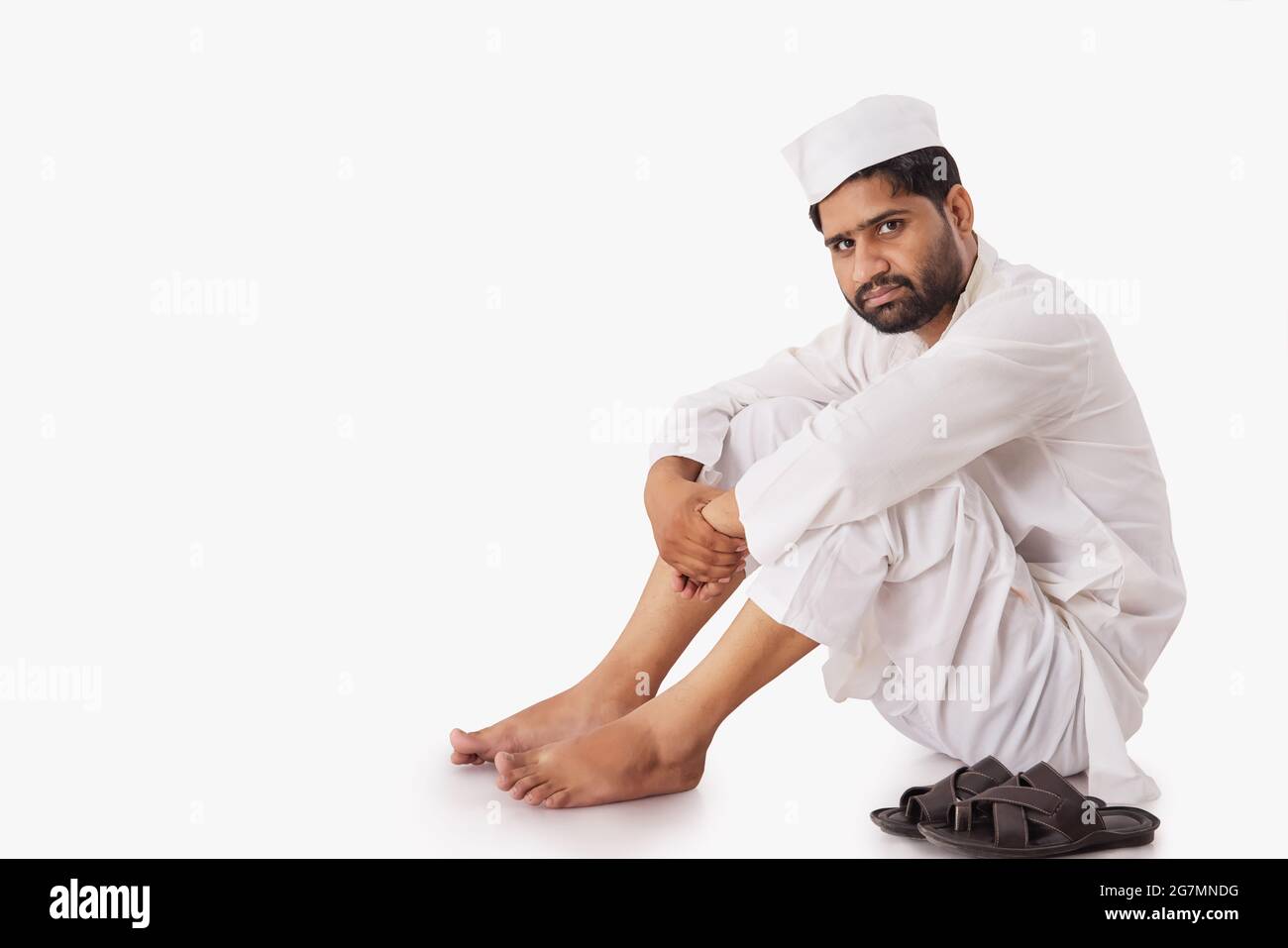 A COMMON MAN SITTING AND LOOKING AT CAMERA Stock Photo