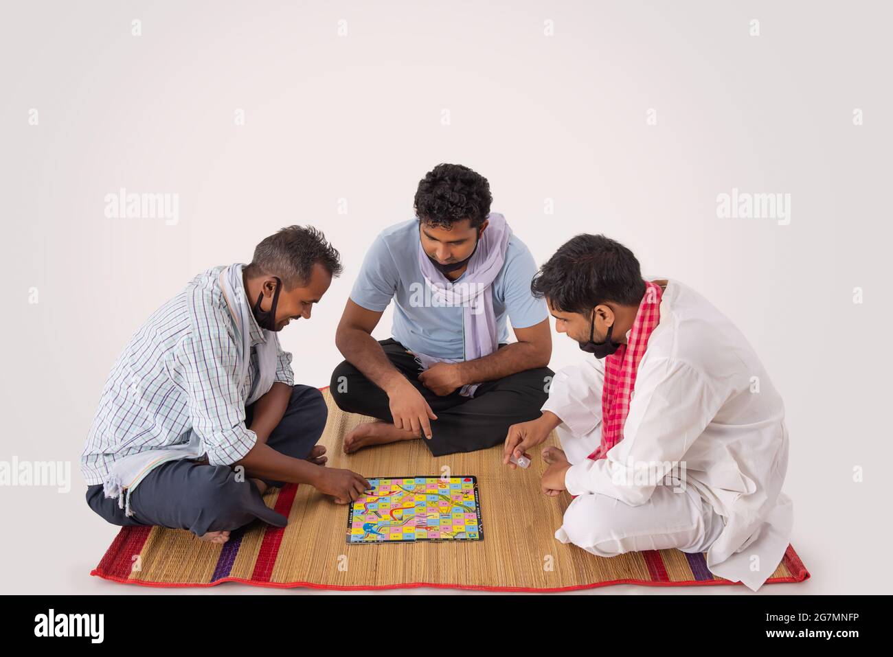 A GROUP OF FRIENDS HAPPILY PLAYING BOARD GAME Stock Photo