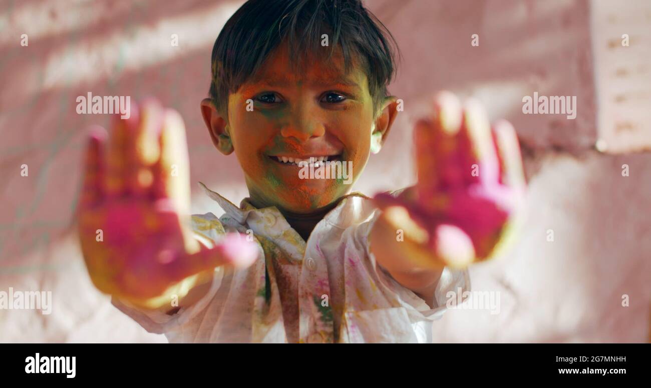 Indian Child Color Hand Indian male kid colored with green face showing his purple hands Stock ...