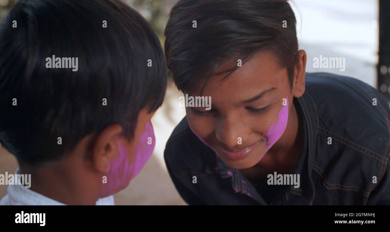 Adorable Indian boys with painted faces on Holi festival Stock Photo