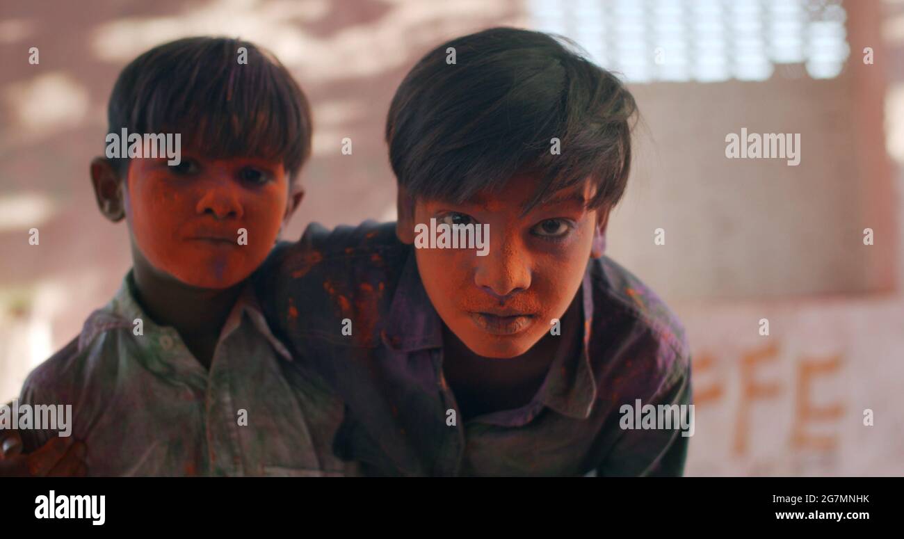 Adorable Indian boys with painted faces on Holi festival Stock Photo