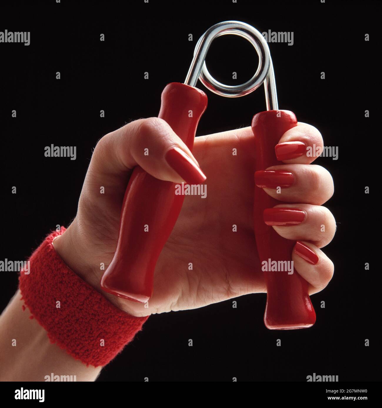 Young woman. Close up of hand using grip exerciser. Stock Photo