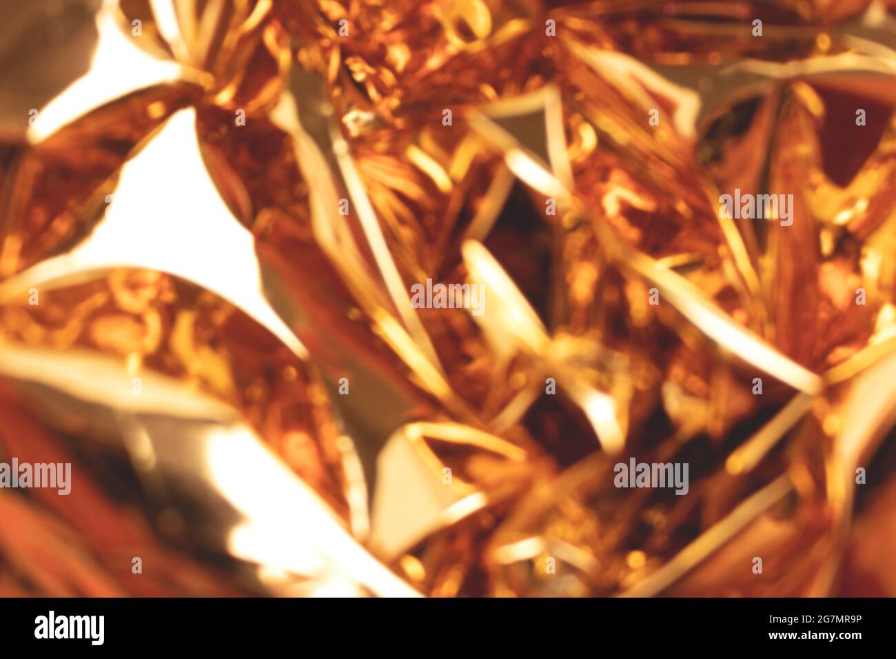Blurred golden foil shiny texture. Soft focus background. Stock Photo
