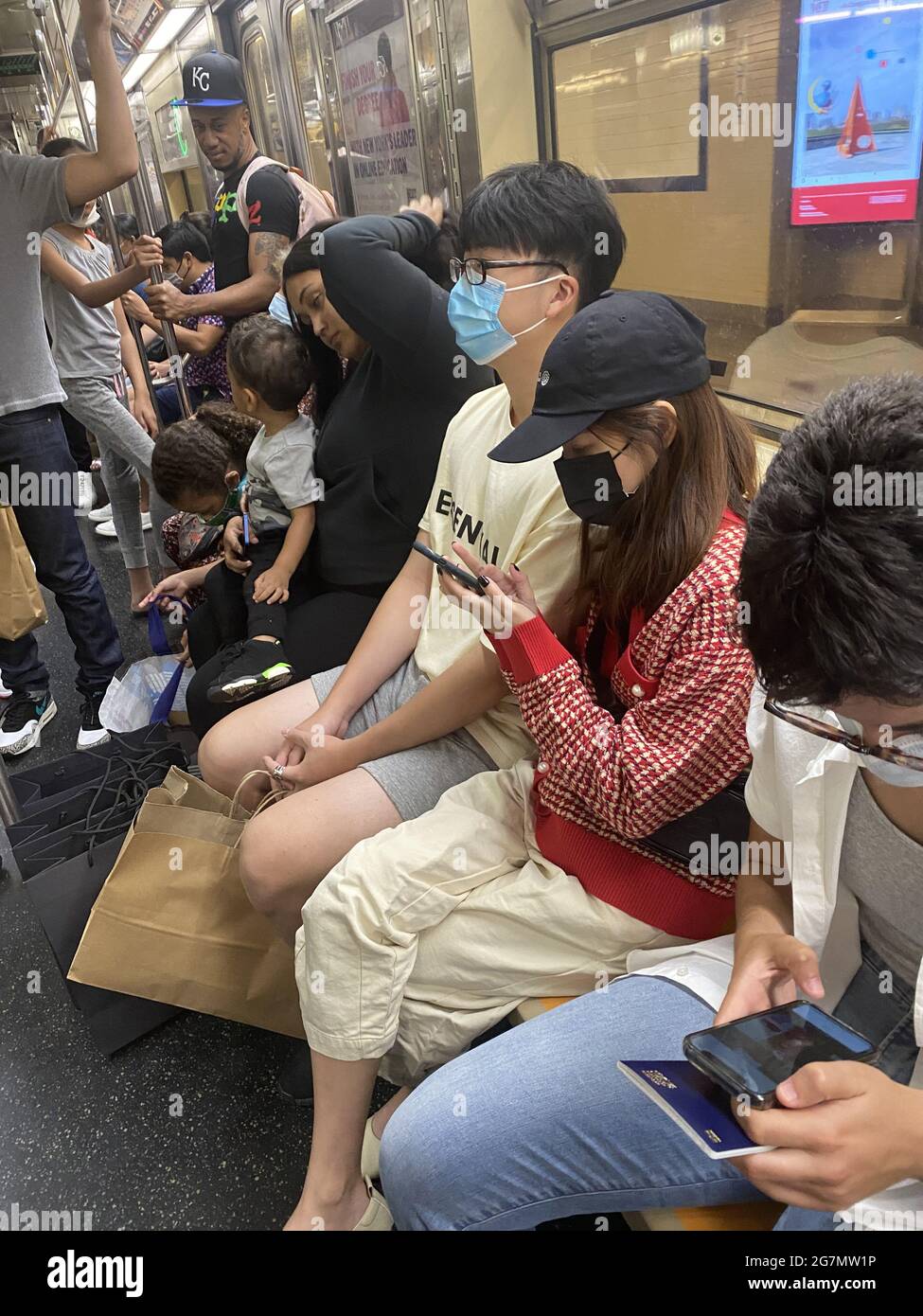 Subway riders still wear masks in New York CIty as the Covid19 restrictions begin to be relaxed