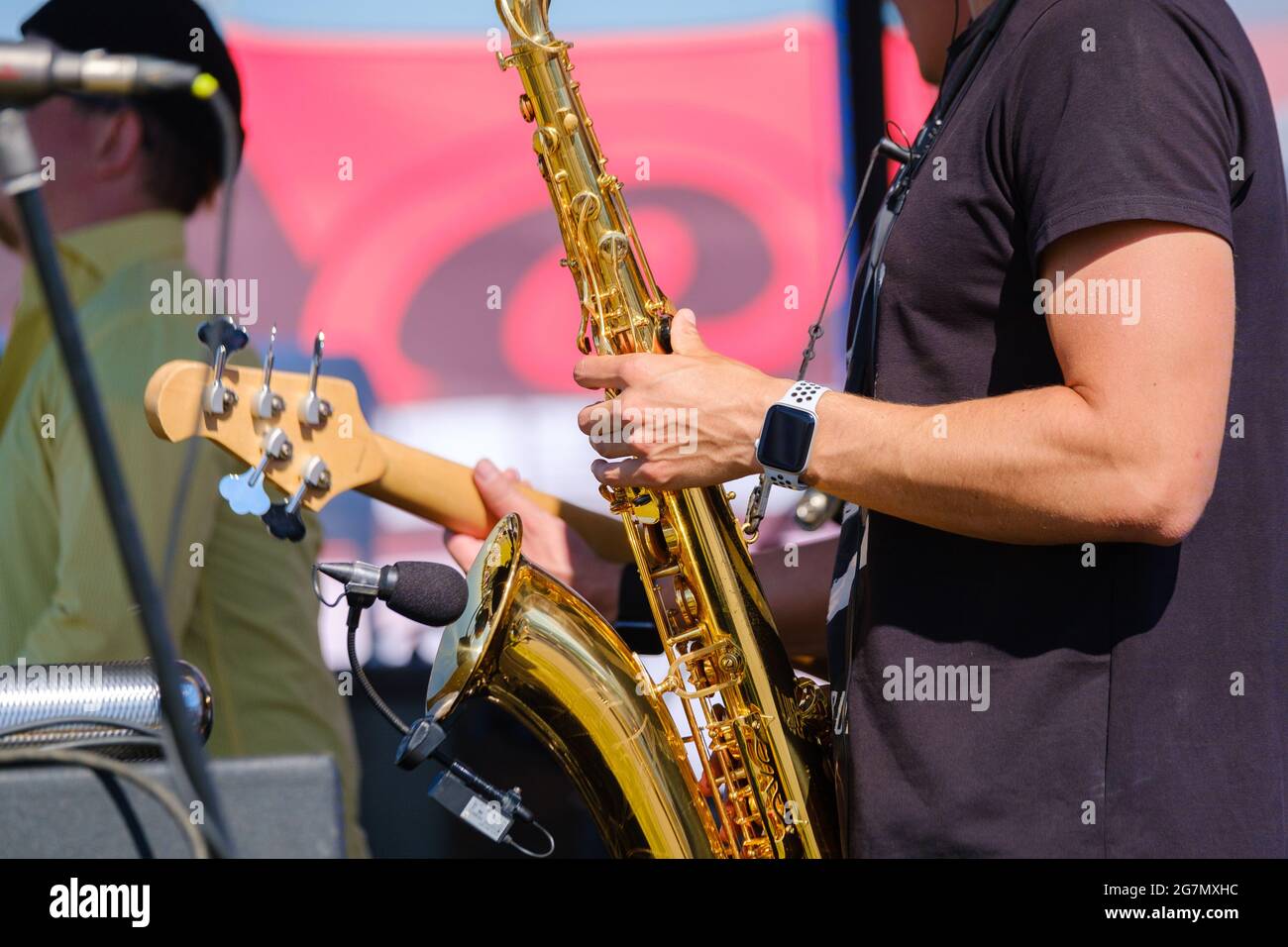 Crop man playing saxophone on street Stock Photo
