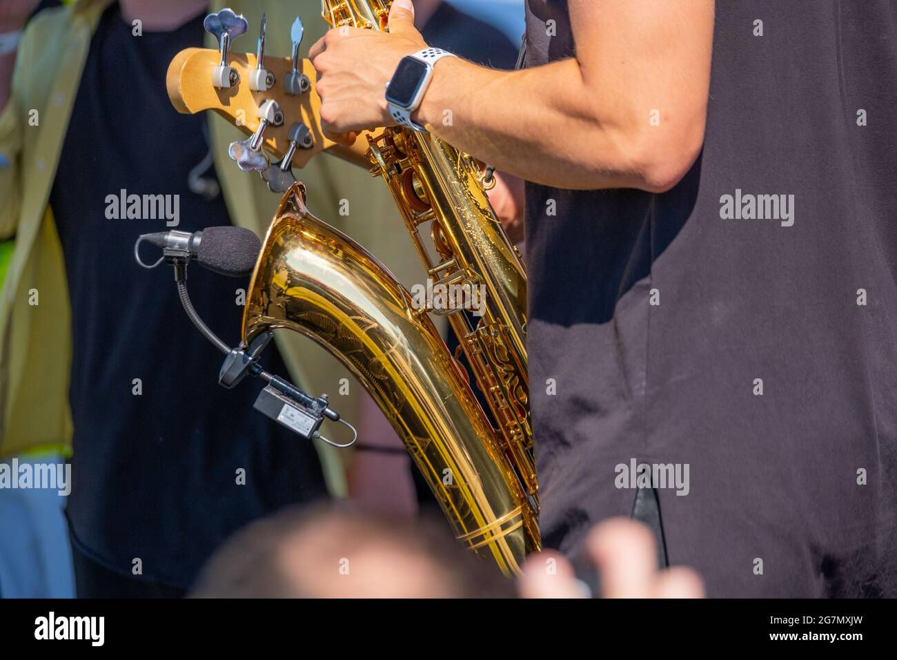 Crop man playing saxophone on street Stock Photo