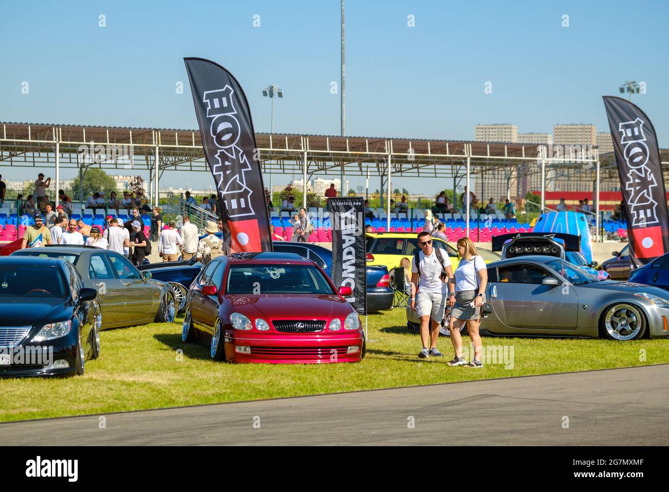 Modern Rally Spectators Spectators looking at modern cars during trade show Stock Photo - Alamy